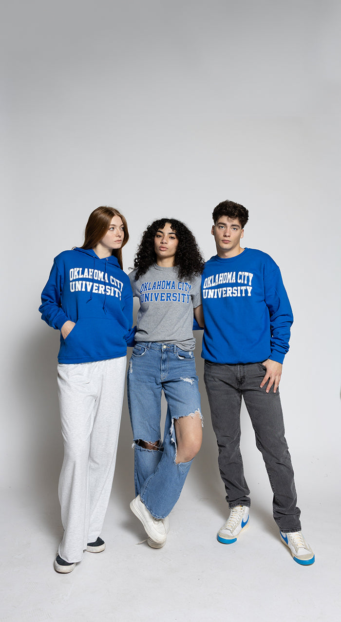 Three people wearing blue 'Oklahoma City University' sweatshirts on a white background
